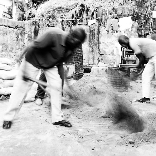 men with shovels mixing cement in Congo
